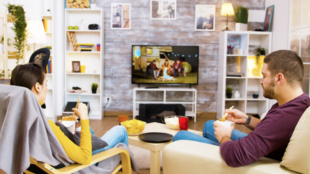Group of friends watching Infinity IPTV together on a smart TV
